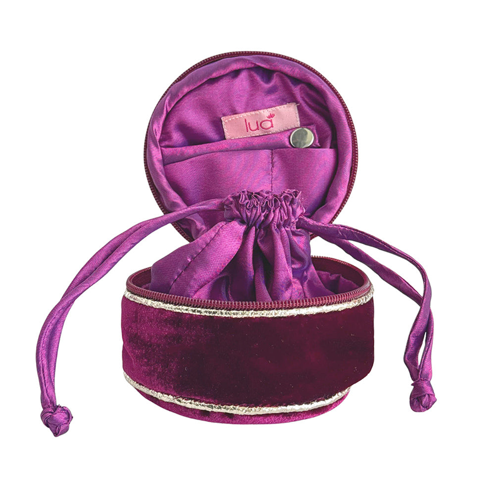 Purple velvet jewelry drawstring pouch with 'lua' brand label on a white background