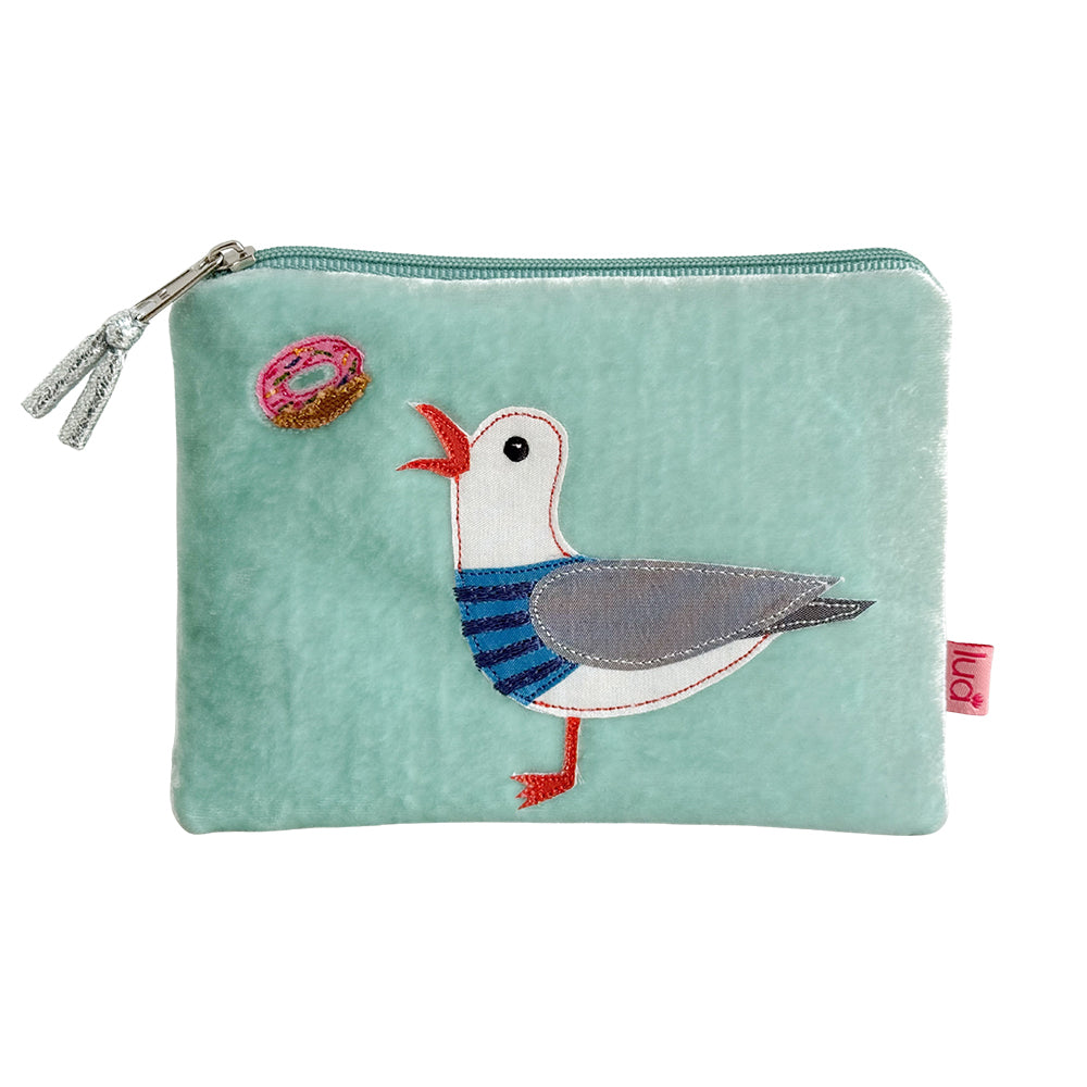 Light blue pouch with a seagull design and a pink donut on a white background
