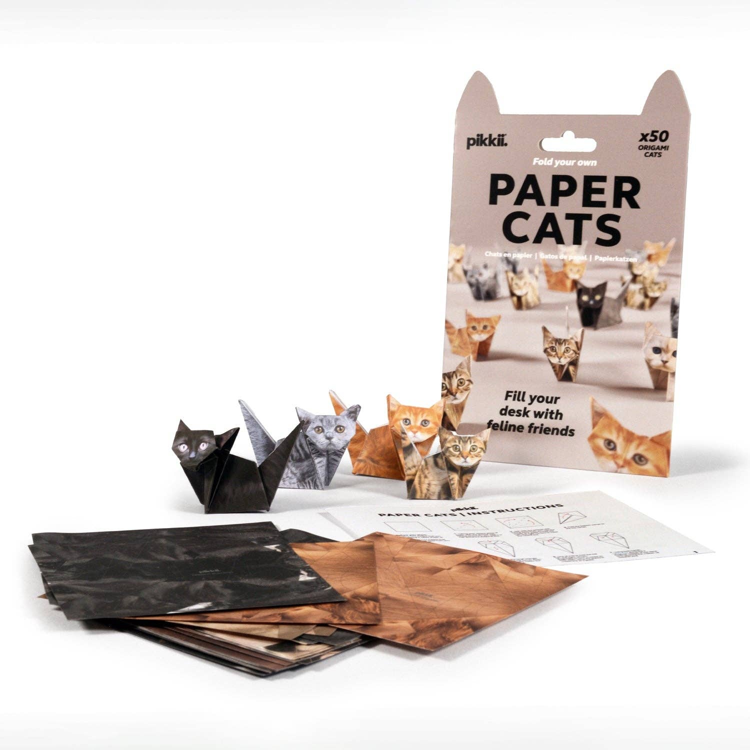 Image shows packaging, flat origami paper, an instruction sheet, and examples of folded origami cats on a white background.