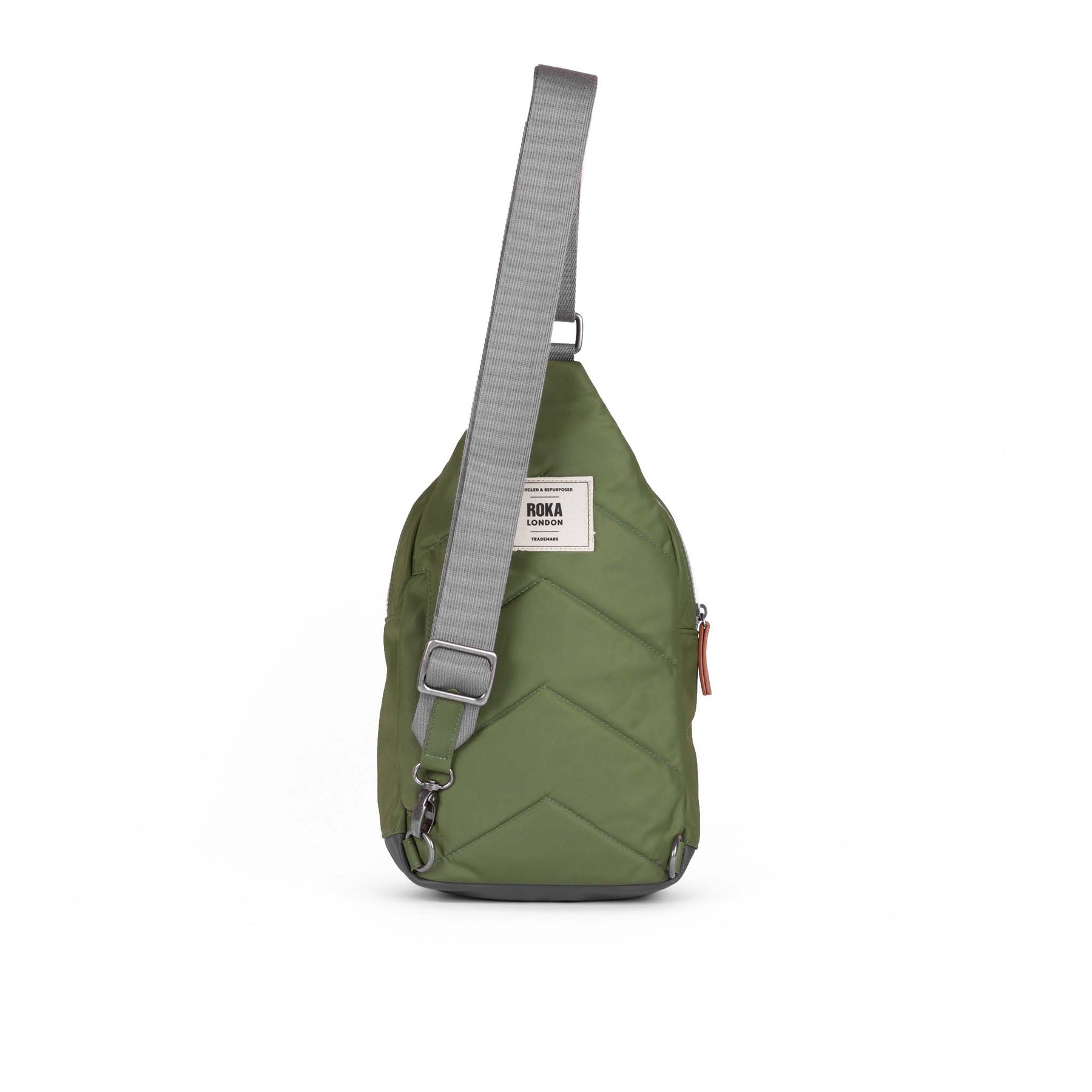 Green crossbody bag with a visible brand label on a white background