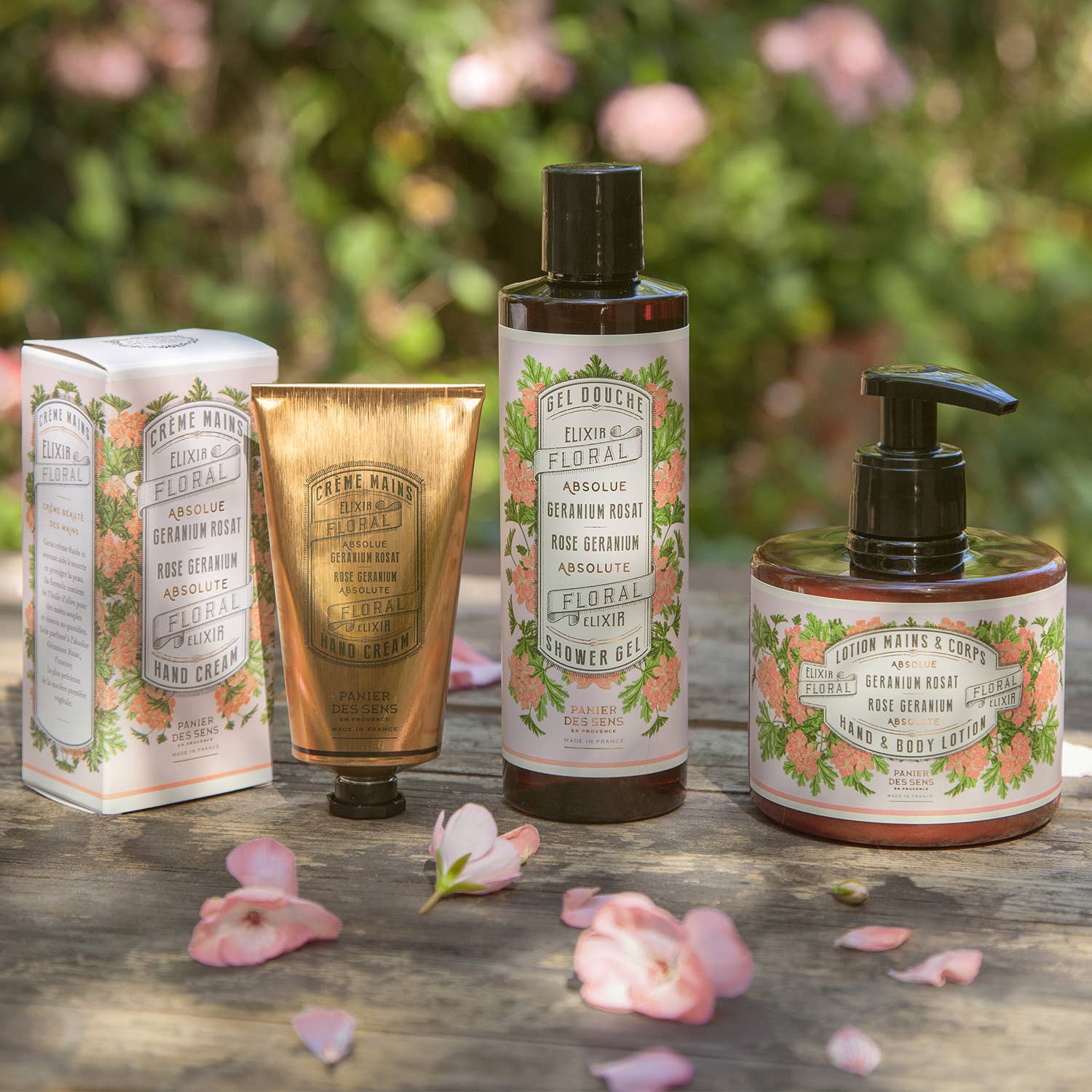Set of rose  skincare products on a wooden surface with floral background