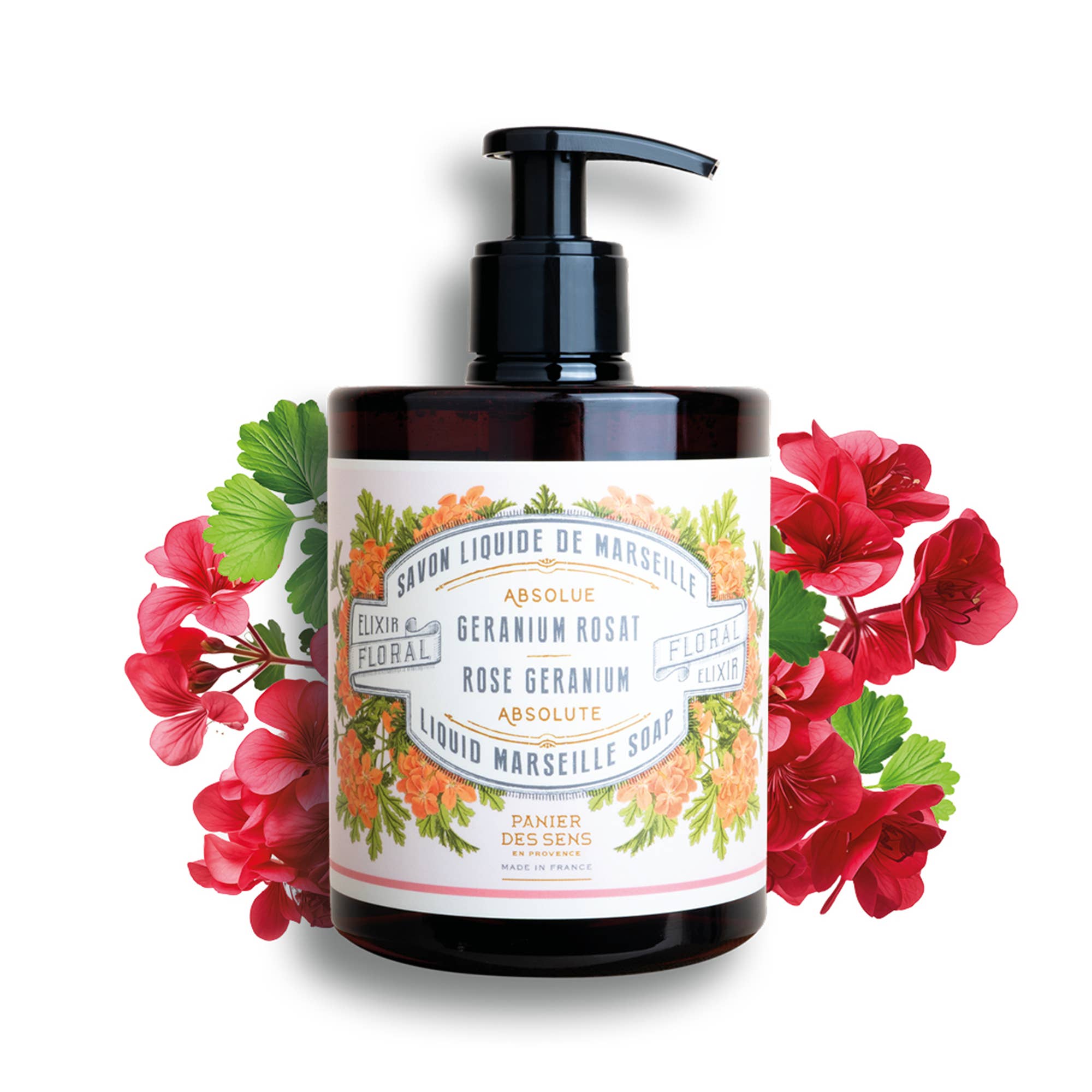 Bottle of Liquid Marseille Soap with floral design on label and red flowers around it