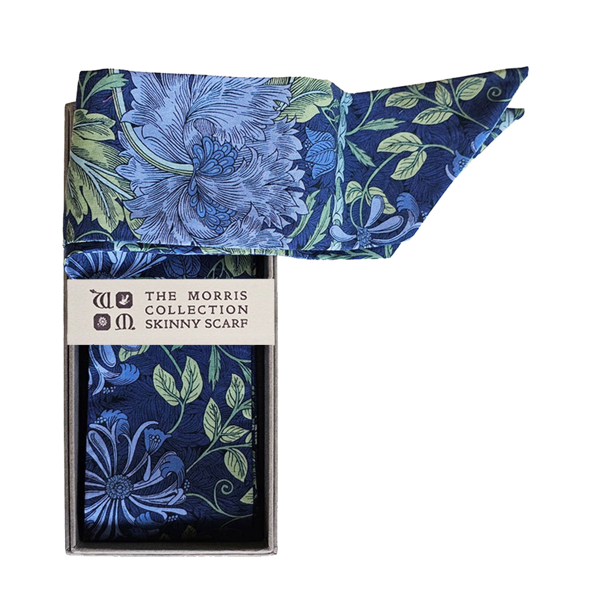 Skinny scarf in botanical themed fabric trailing out of a grey presentation box with “The Morris Collection” branding. 