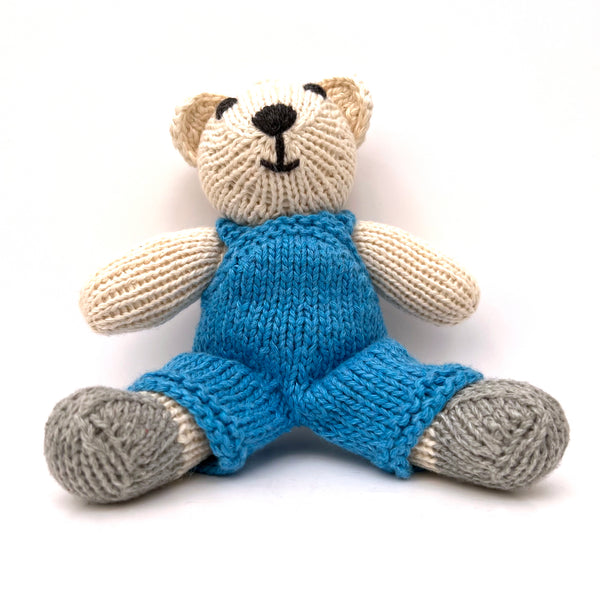 knitted soft toy polar bear in blue dungarees