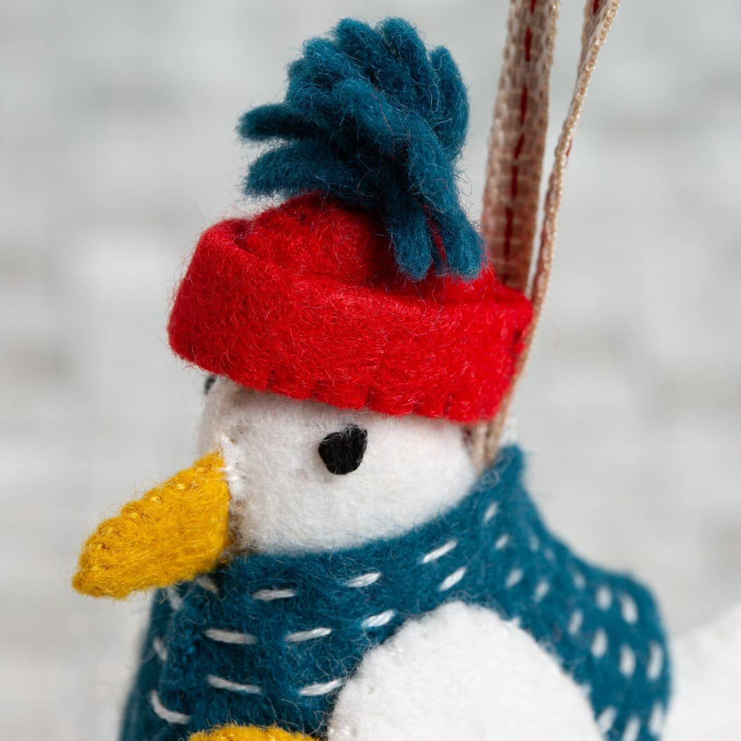 Detail image showing the seagull toys red and blue hat, face and blue jacket. 