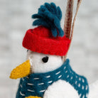 Detail image showing the seagull toys red and blue hat, face and blue jacket. 