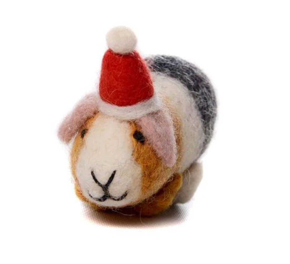A plush toy resembling a guinea pig wearing a Santa hat made of felt.