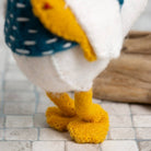 Close-up of a seagull with yellow feet on a tiled floor