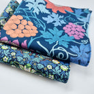 Stack of colourful floral fabric hankies on a white background