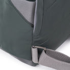Close-up of a green bag with a strap on a white background