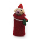 A handmade felt Christmas pig decoration wrapped in a red Santa hat and red blanket, with green holly leaves, on a white background.