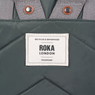 Close up of a Roka London label on a green bag