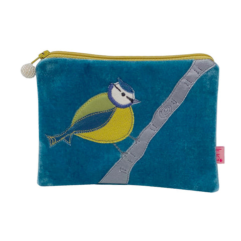 small rectangular purse made from blue velvet with a blue, green and yellow bird sitting on a branch appliquéd onto the front.