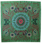 Decorative fabric with a central floral design on a green background