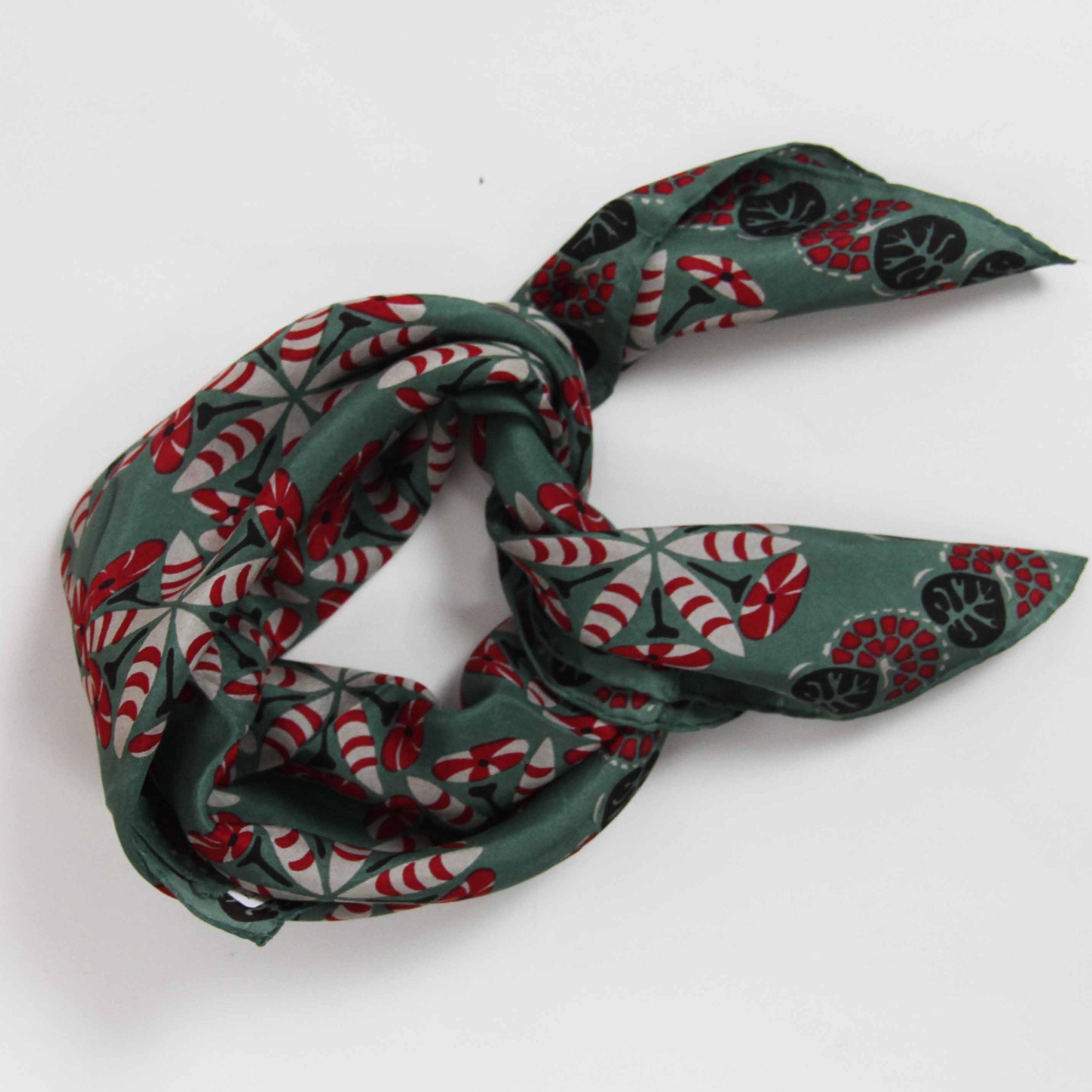 Green patterned scarf tied in a knot on a white background