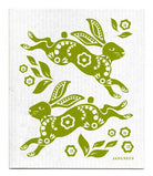 Green rabbits with floral patterns on a white cloth, featuring the brand 'Jangneus'.