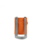 A photo of the back of a small rectangular orange pocket bag. It has a pocket and grey straps.