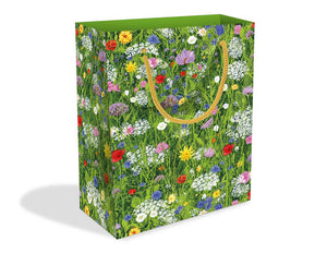 Short rectangular gift bag with white, red, pink, purple and yellow flowers in a green field