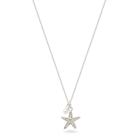 starfish and pearl necklace on white background 